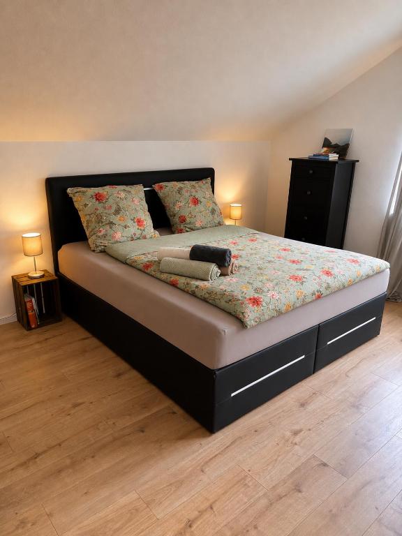 a bedroom with a bed with a floral bedspread at Haus Johannes in Braubach