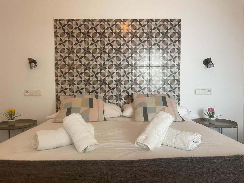 a bedroom with a large bed with a large headboard at Patio de Los Barberos in Valle de Abdalagís