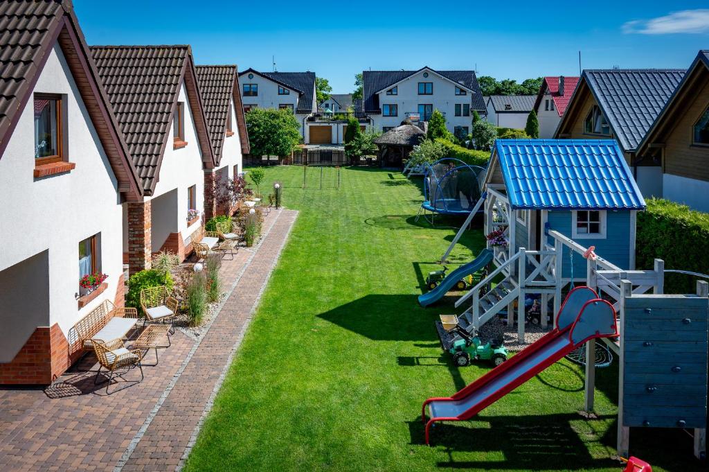 a backyard with a playground and a slide at Domki Oaza Spokoju in Nowęcin
