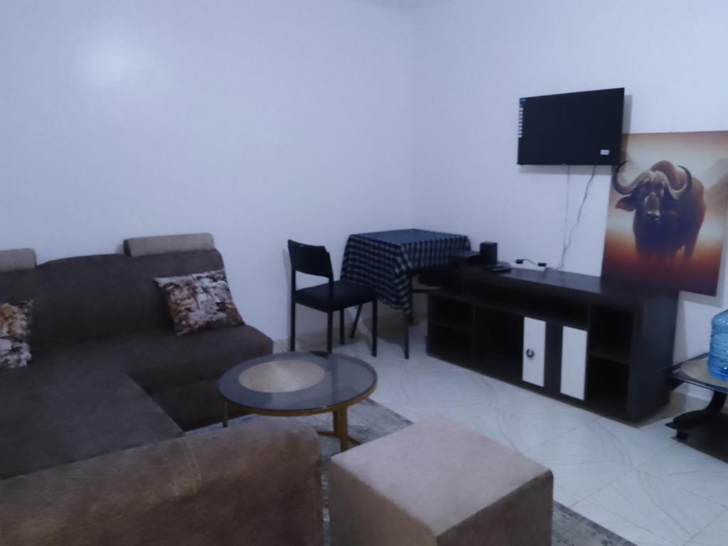 a living room with a couch and a table at Kiserian in Kitengela 