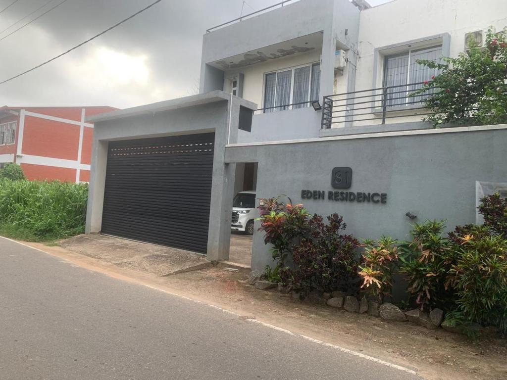 a building with a garage door in front of it at Airport Transit Home in Ja-Ela