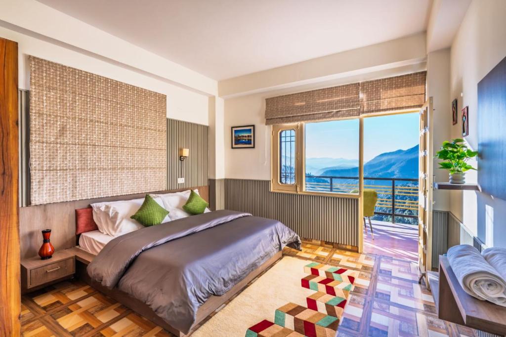 a bedroom with a bed and a large window at Shiwalik Hills in Shimla