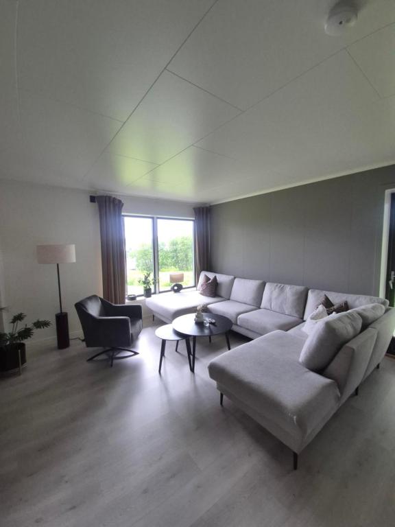 a living room with a couch and a table at Senja Laukhella in Senja