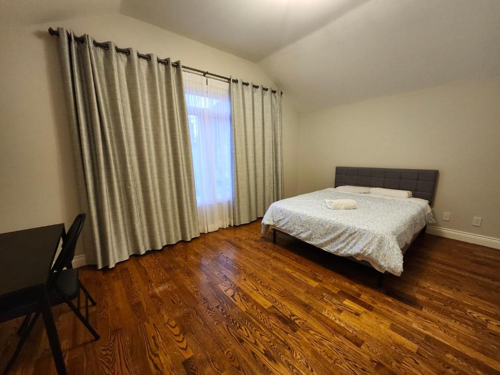a bedroom with a bed and a large window at Executive Room in North York Centre in Toronto