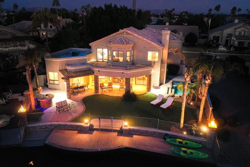 an aerial view of a house at night with lights at Lakeside Luxury Val Vista in Gilbert