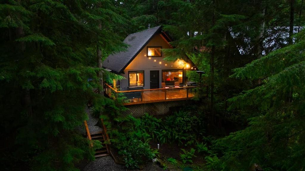 a small house in the woods at night at Hidden Fern Cabin in Glacier
