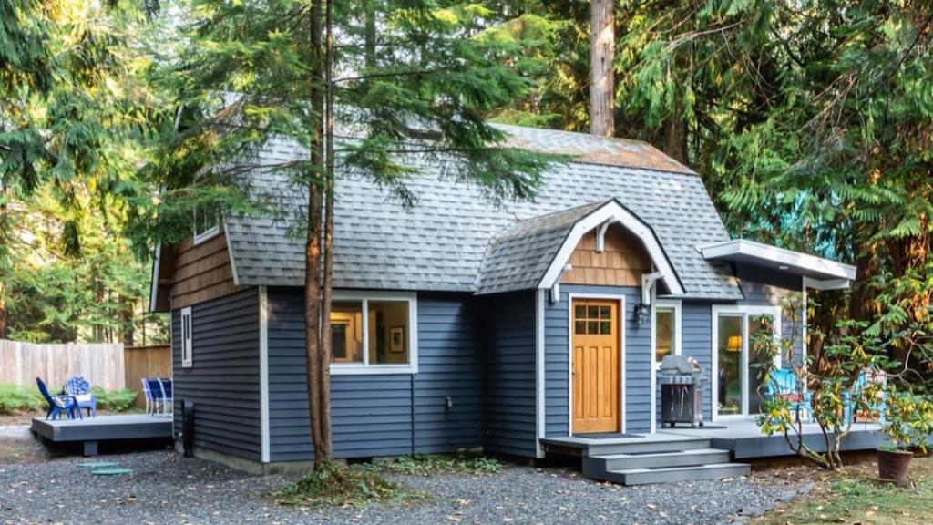 a blue tiny house in the woods at Kulshan Cabin in Glacier
