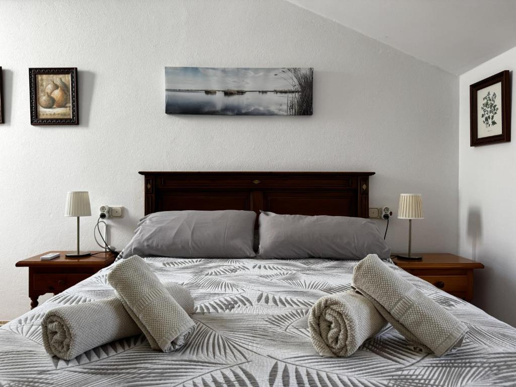 a bedroom with a bed with two pillows on it at Casa Los Barberos in Valle de Abdalagís