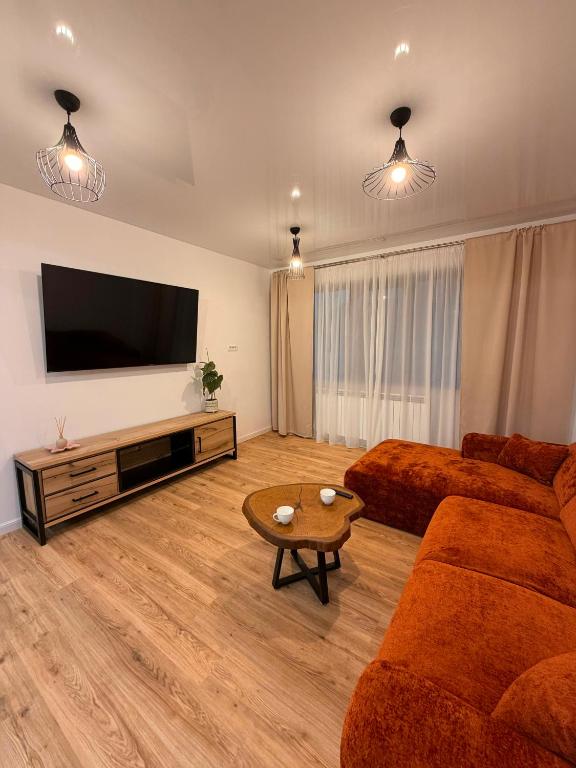 a living room with two couches and a flat screen tv at Livia Residence II in Constanţa
