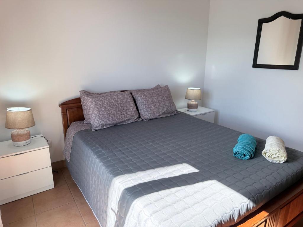 a bedroom with a bed and two night stands at Casa Sentir a Maia in Maia