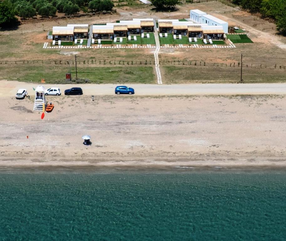 an aerial view of a beach with cars and a parking lot at Almond Beachfront Resort - kalyves Halkidiki in Kalives Poligirou