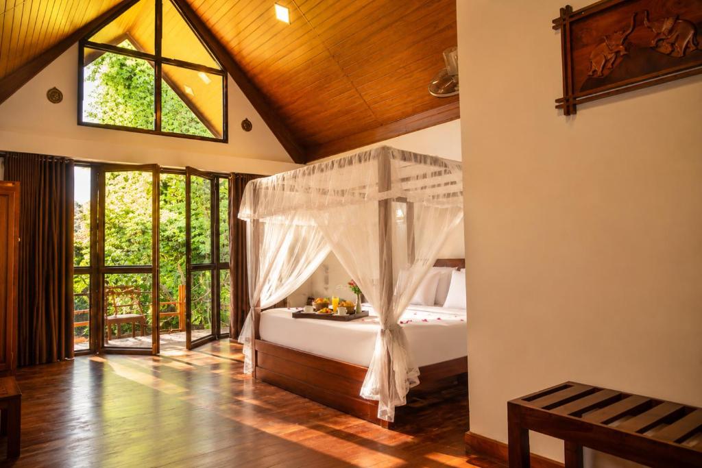 a bedroom with a bed with a canopy at Sunrise Mount View in Ella