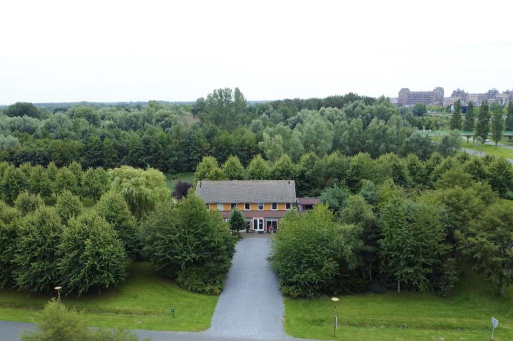 an aerial view of a house with a road at La Belle Heure B&B - formerly Huis van Steen - in Lelystad