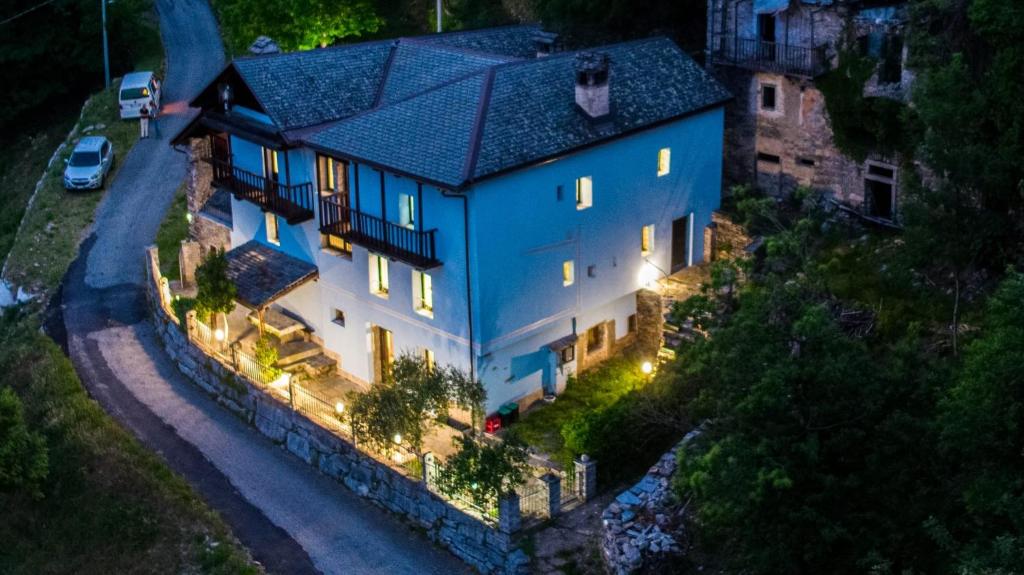 an overhead view of a large blue house with lights at Residenza Villa Paradiso in Villadossola