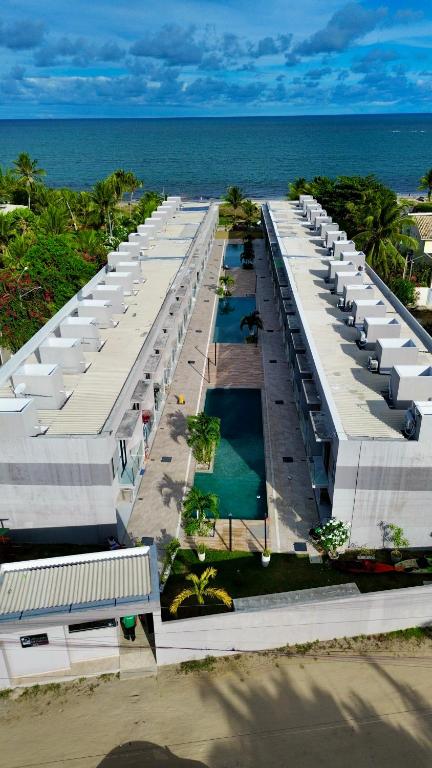 an aerial view of a building on the beach at Flat Forte Orange - Ilha de Itamaracá in Itamaracá