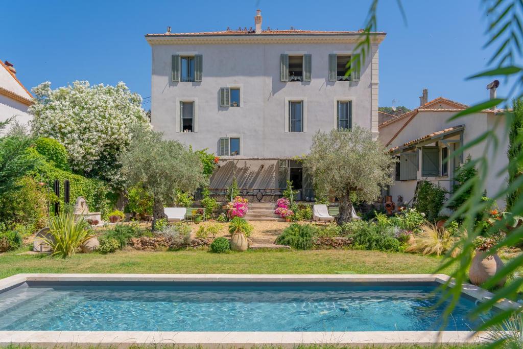 a house with a swimming pool in front of a building at Maison Aimé in La Motte