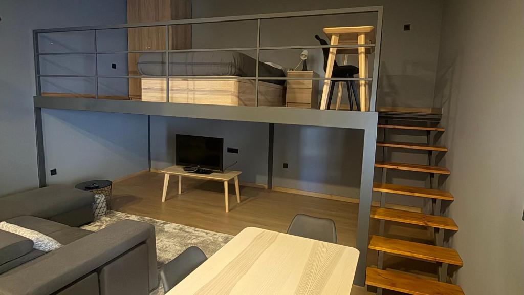 a living room with a loft bed and a table at Matosinhos Urban Loft in Matosinhos