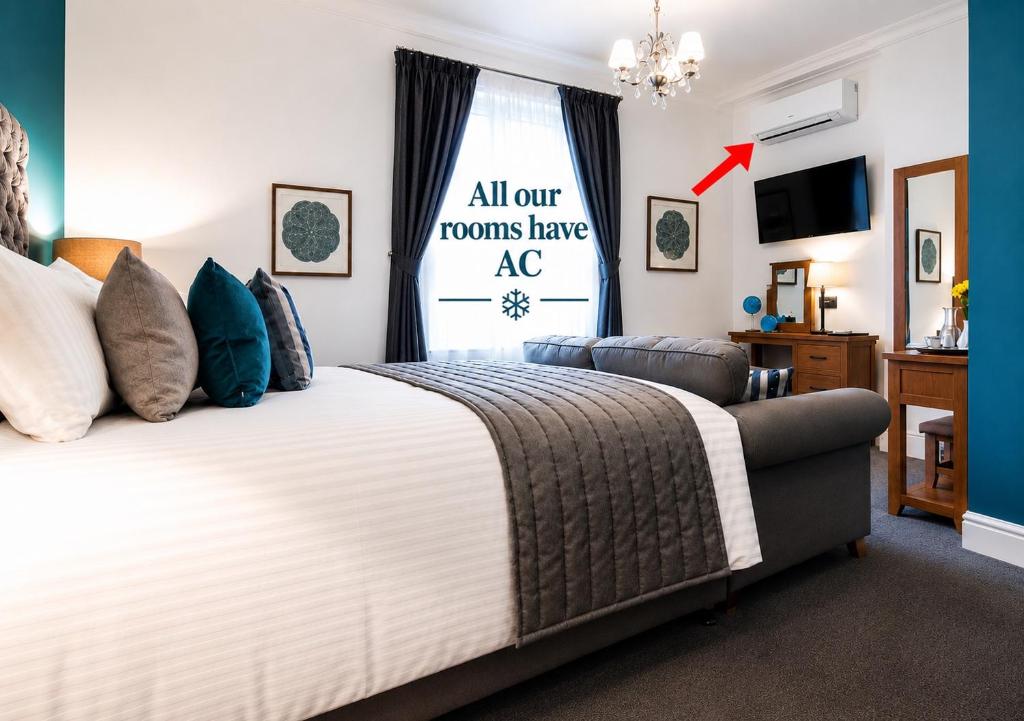 a bedroom with a large bed and a window at Tyndale Boutique B&B - Adults Only in Torquay