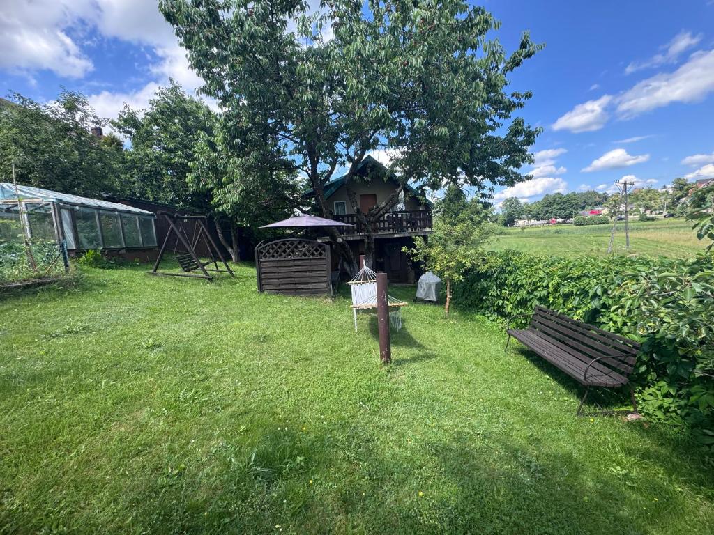 a park with a gazebo and a bench in the grass at Domek u Moni Kaszuby in Sulęczyno