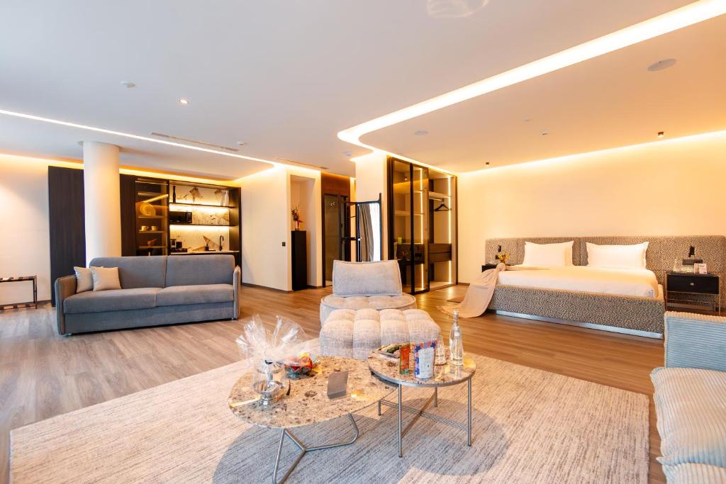a hotel room with a bed and a living room at Suites By Le Rêve in Tangier
