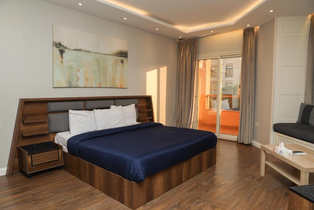 a bedroom with a bed and a couch in a room at Munir`s residence 2 in Cairo