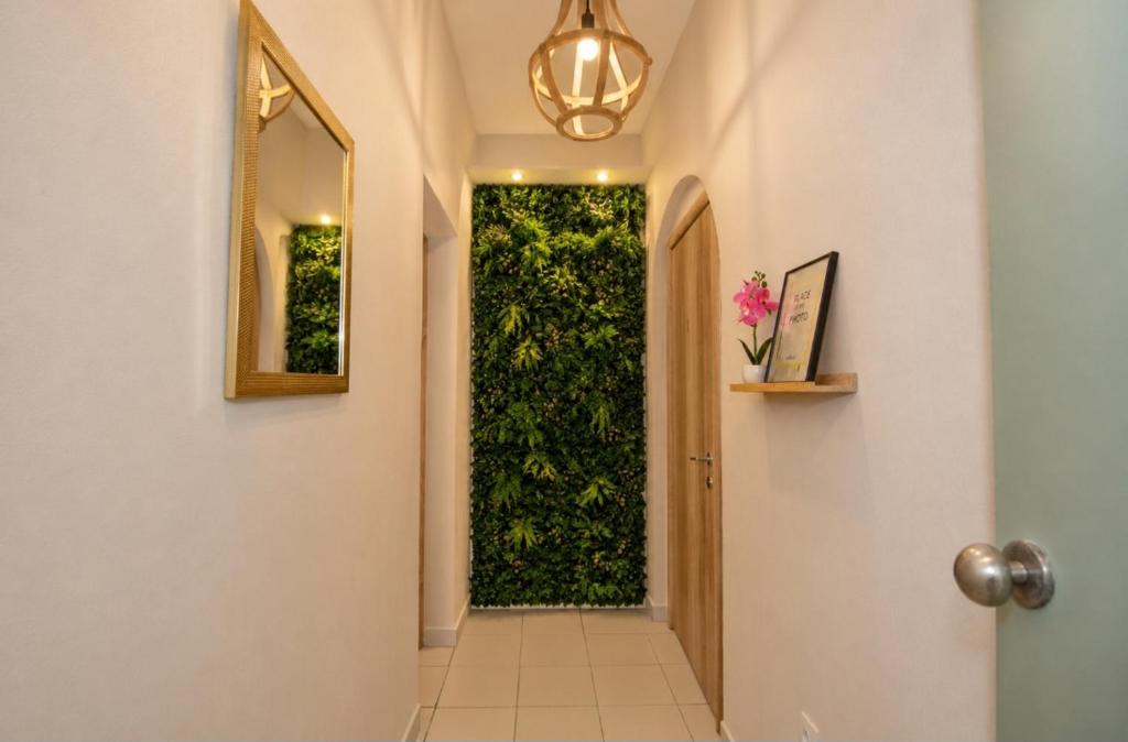 a hallway with a door with a green hedge at Olympian Kavala in Kavála