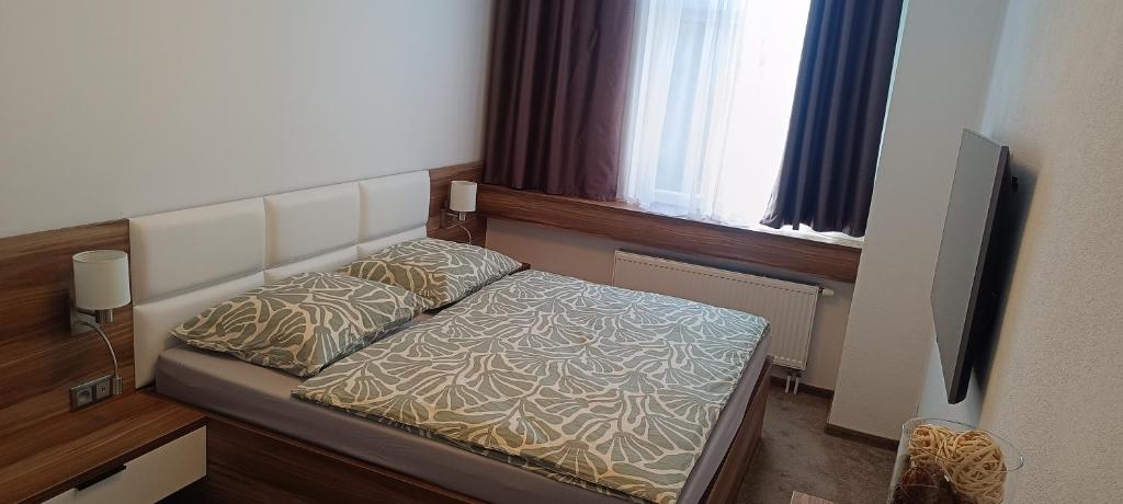 a small bed in a room with a television at Tami Apartman Hviezdoslavova 2, Liptovsky Mikulas, Private Parking in Liptovský Mikuláš