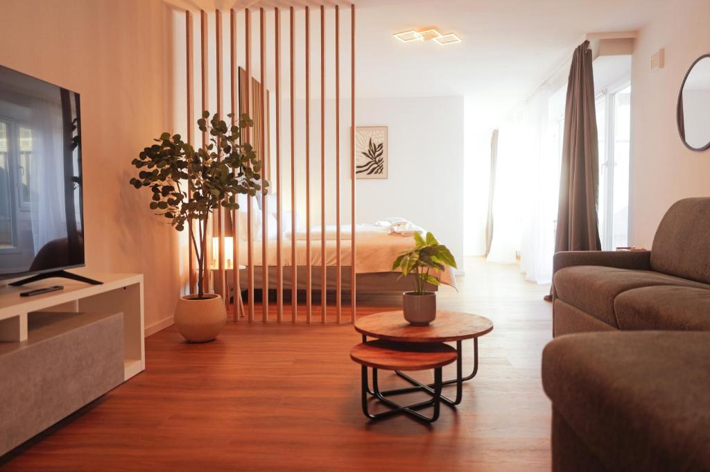 a living room with a couch and a table at Black Forest Living am Marktplatz in Freudenstadt