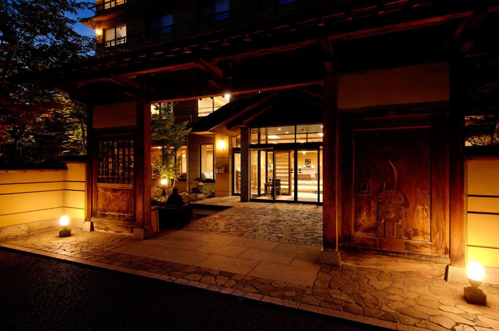 einen Eingang zu einem Gebäude in der Nacht mit Lichtern in der Unterkunft Shibu Hotel in Yamanouchi