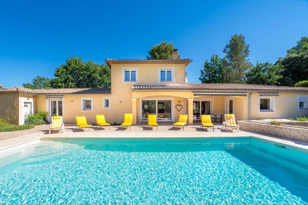 a villa with a swimming pool in front of a house at La Bastide au Soleil in Flayosc