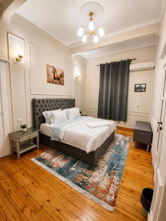 a bedroom with a bed and a rug at Yacoubian Suites in Cairo