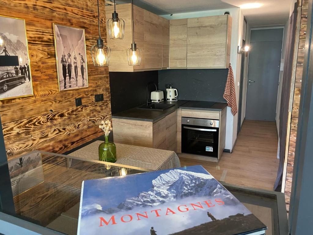 a kitchen with a table with a book on it at Panorama à La Mongie in La Mongie