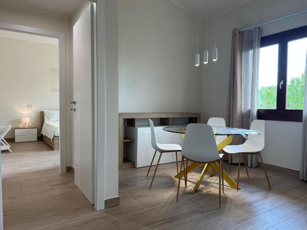 a living room with a dining room table and chairs at Casa Tanca Marchese in Marrùbiu