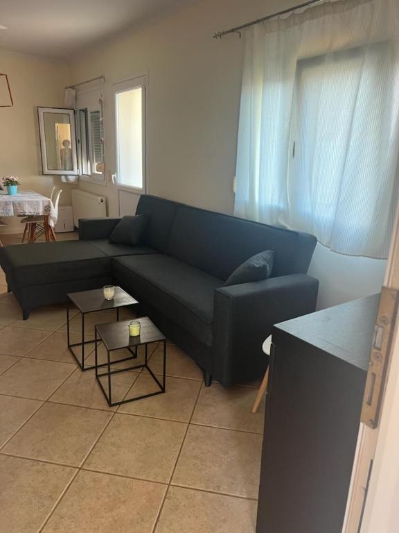 a living room with a blue couch and a table at Renas' Apartments in Chios island in Chios