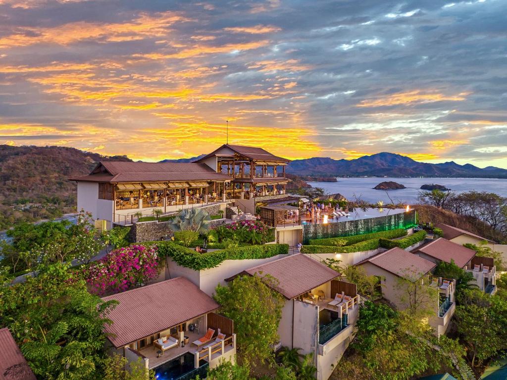 an aerial view of a resort with a sunset at Casa Chameleon Hotel Las Catalinas - Adults Only in Playa Flamingo