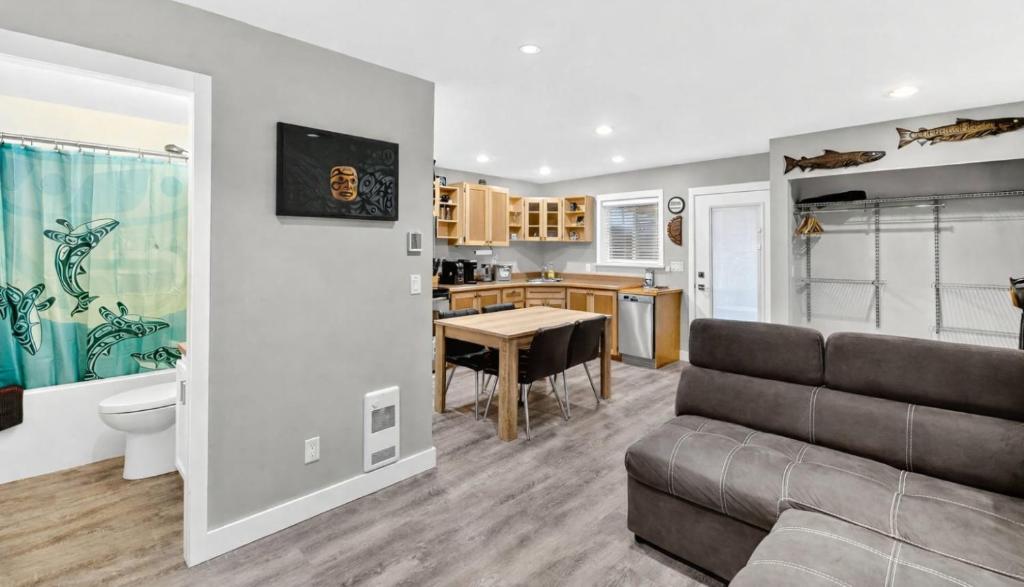 a living room with a couch and a table at Chims Cabins - Port Alberni in Port Alberni