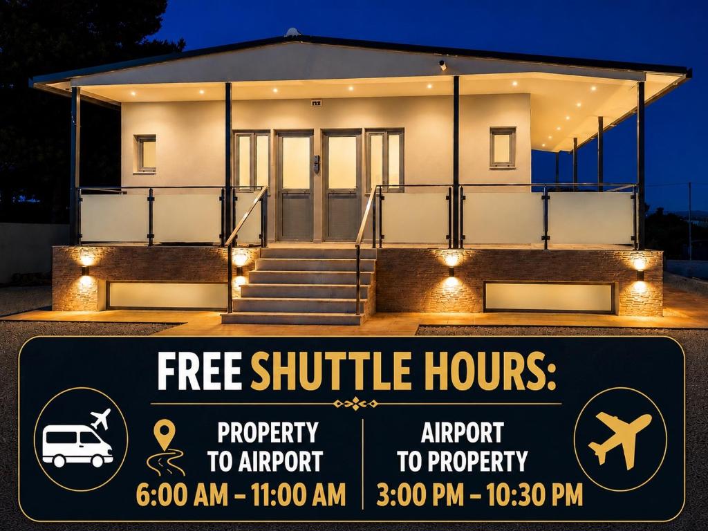 a house with a sign in front of it at Maxa Residences - Free Airport Shuttle in Artemida
