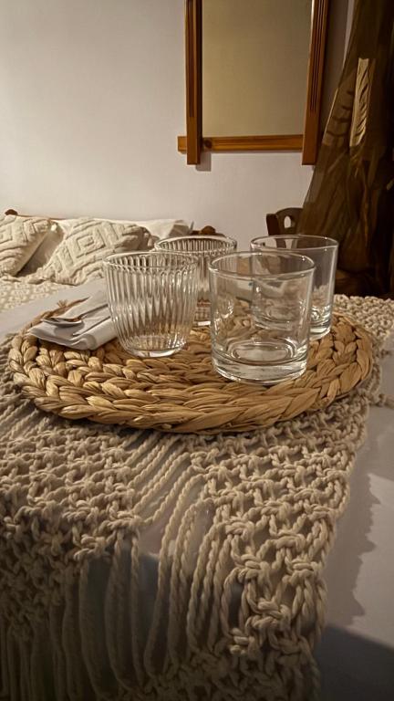 a table with glasses on top of a bed at Harama Living Finikas in Livanianá