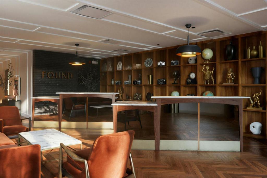 a room with two tables and chairs and shelves at FOUND Hotels, Chicago, Series by Marriott in Chicago