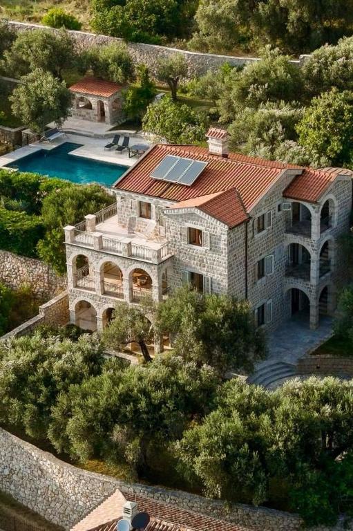 an aerial view of a house with a swimming pool at Villa Olive Grove in Budva