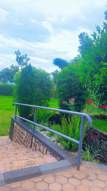 a bench sitting on a brick path in a park at Lavender Garden Kabarondo in Kayonza