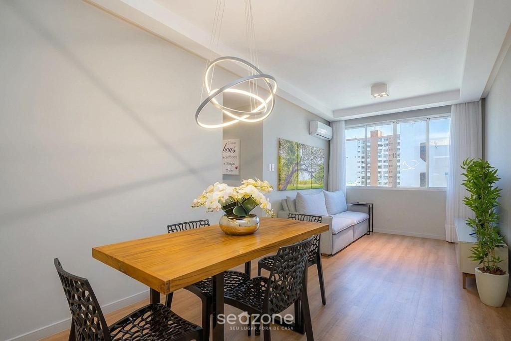 a dining room with a wooden table and chairs at Charming apartment in downtown Floripa EDC402 in Florianópolis