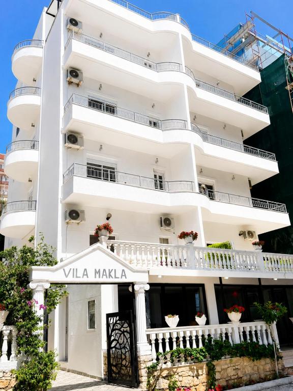a white building with a sign that reads vla makela at Vila Makla in Sarandë