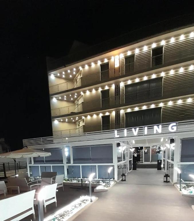 a lit up building with lights on it at night at Hotel Living in Casoria