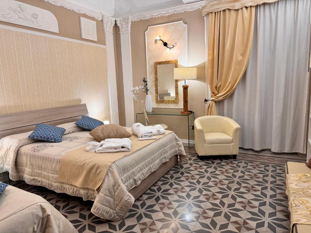 a hotel room with two beds and a chair at Casa Costanza 25 in San Cipirello