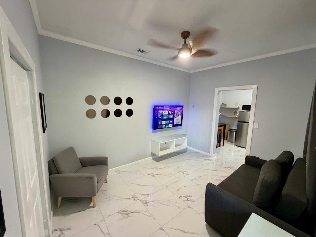 a living room with a couch and a tv at View Private Suite near LEGOLAND, Downtown & Hospital in Winter Haven