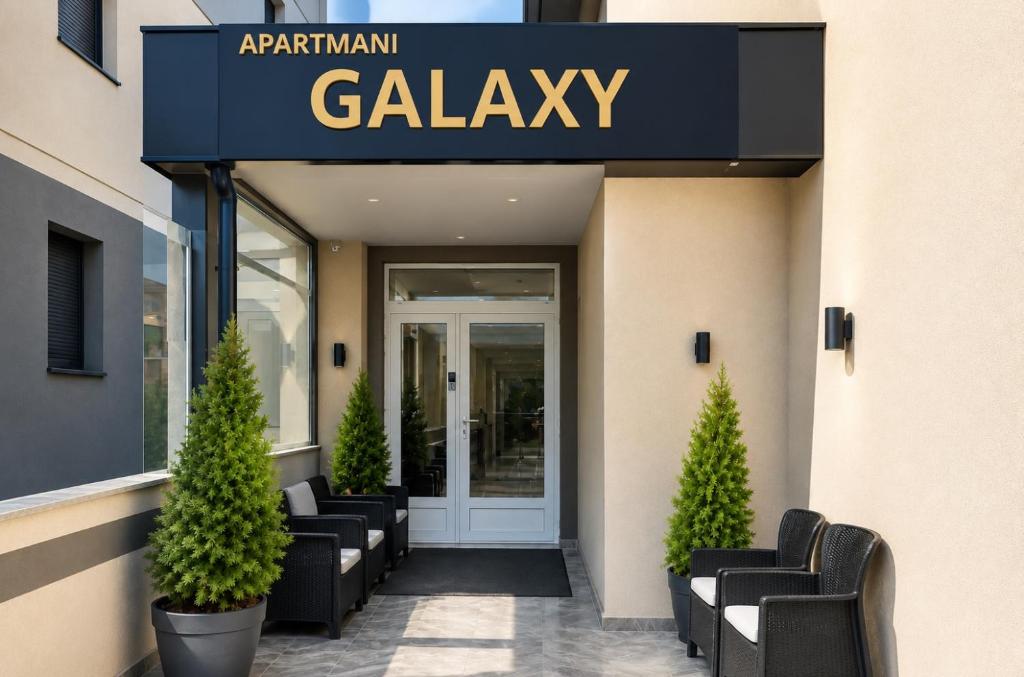 a lobby with chairs and a sign that reads galeasy at Galaxy Apartments in Belgrade
