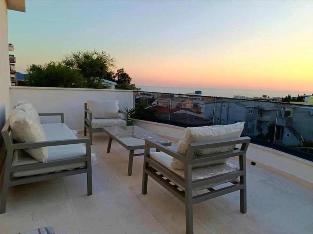 a patio with two chairs and a table on a balcony at Apartment Bogunovic in Bar