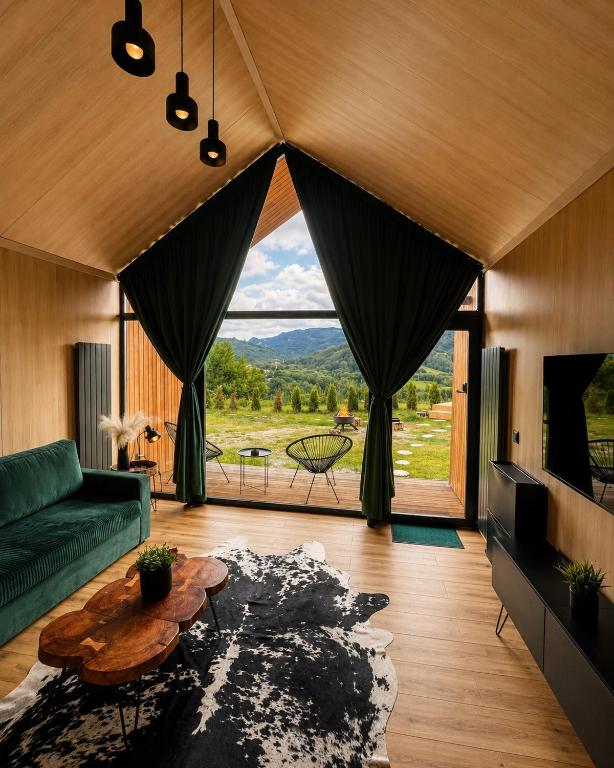 a living room with a couch and a table at The Landscape Barn Homes in Râşnov