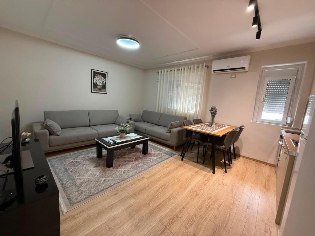 a living room with a couch and a table at Lenci's Apartment in Berat